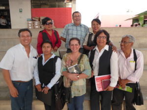 Group of teachers standing on steps of school after training completed in Peru