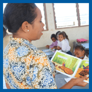 Teacher reading to students in Timor Leste