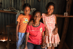 Juliana with her mum and sister at home